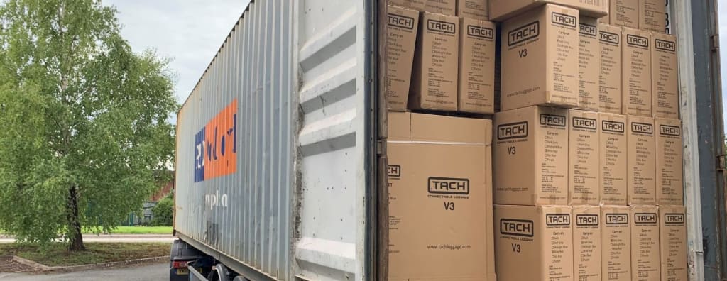 Tach Luggage arriving via shipping container