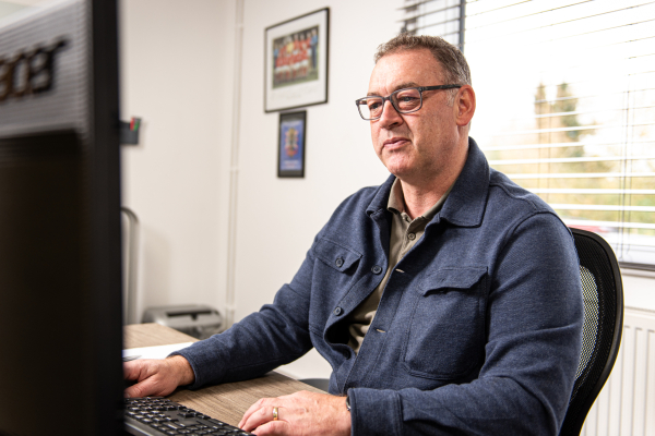 Outsourced Data Cleaning Finance Director checking stats and reports from different clients.