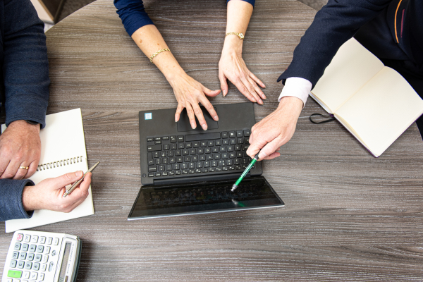 Outsourced Data Cleaning Solutions Colleagues pointing to key areas when analysing sections of the business.